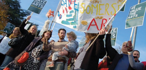 Families holding up protest signs